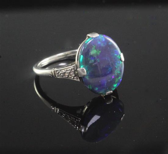 A 1940s 18ct white gold, platinum and black opal ring with diamond set shoulders, size M.